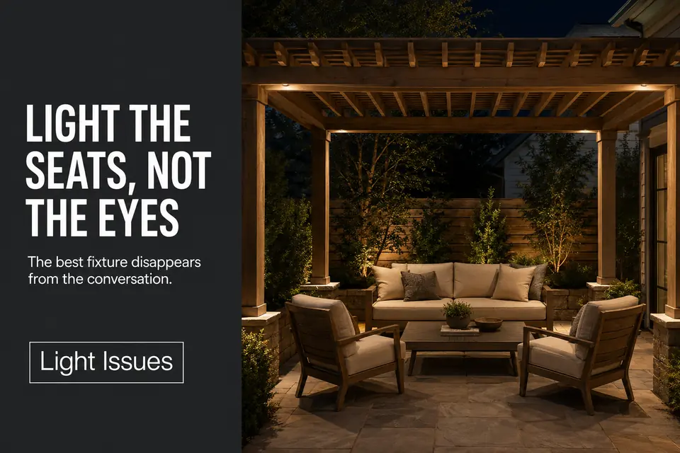 Warm shielded pergola lighting softly illuminating lounge chairs and a coffee table without visible glare.